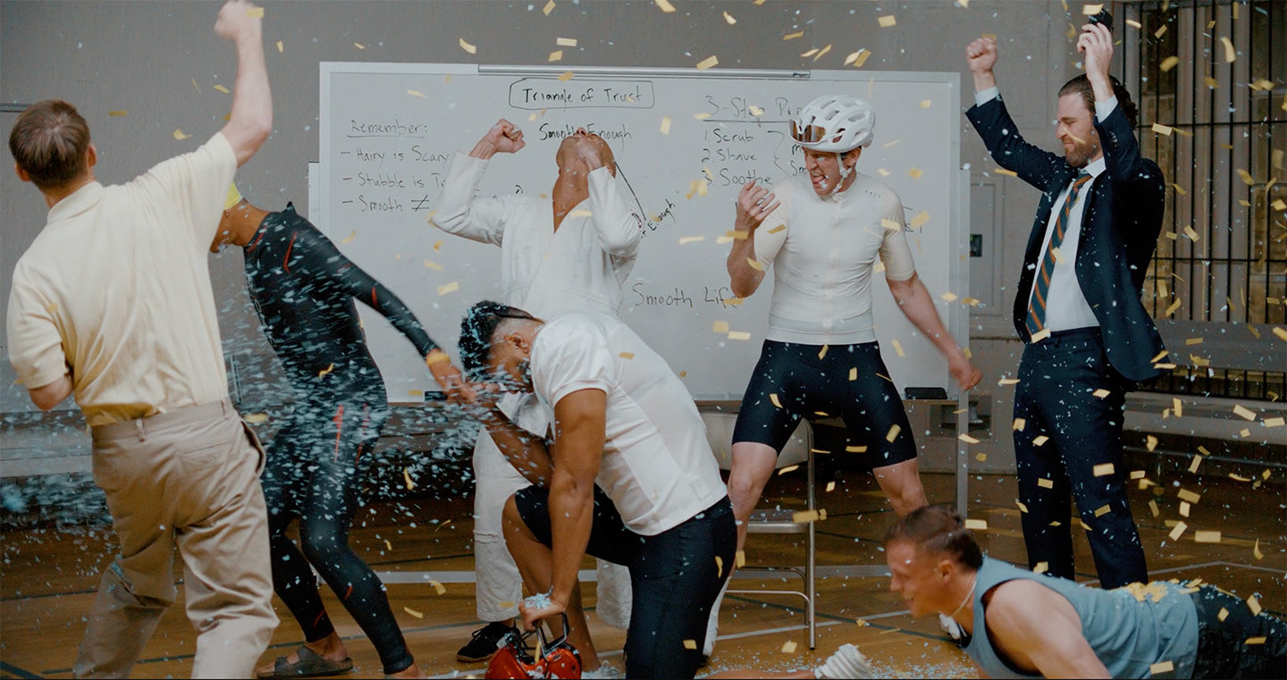 7 guys partying in an office setting with confetti in the air